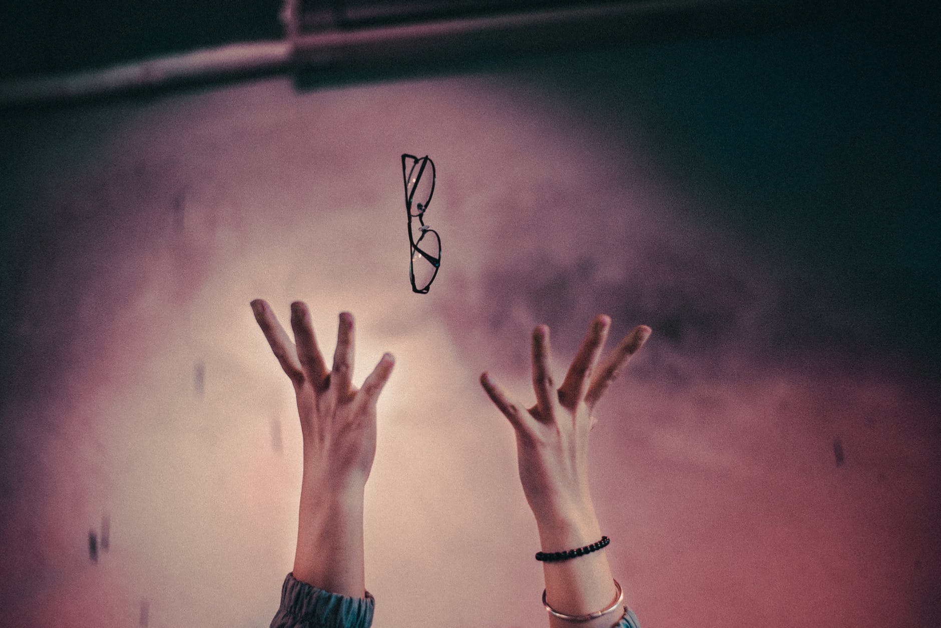 person tossing it s eyeglasses